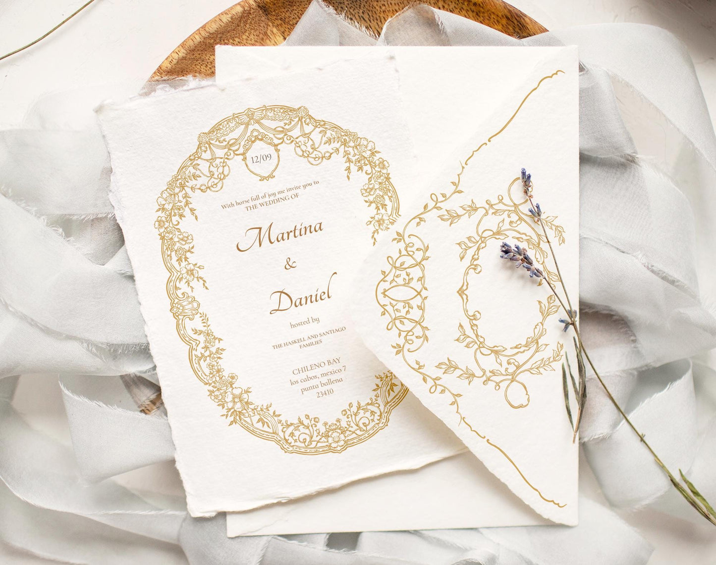 Wedding invitation suite featuring Ornella Gold oval crest and gold floral border