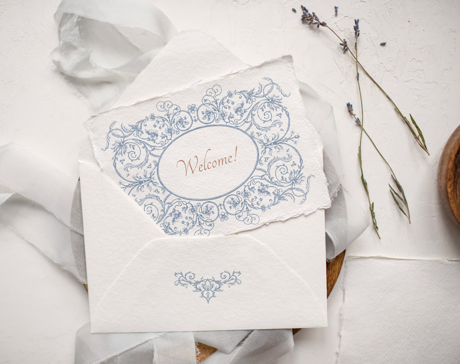 Envelope with ‘Welcome’ label framed by Floral Aesthetics oval border