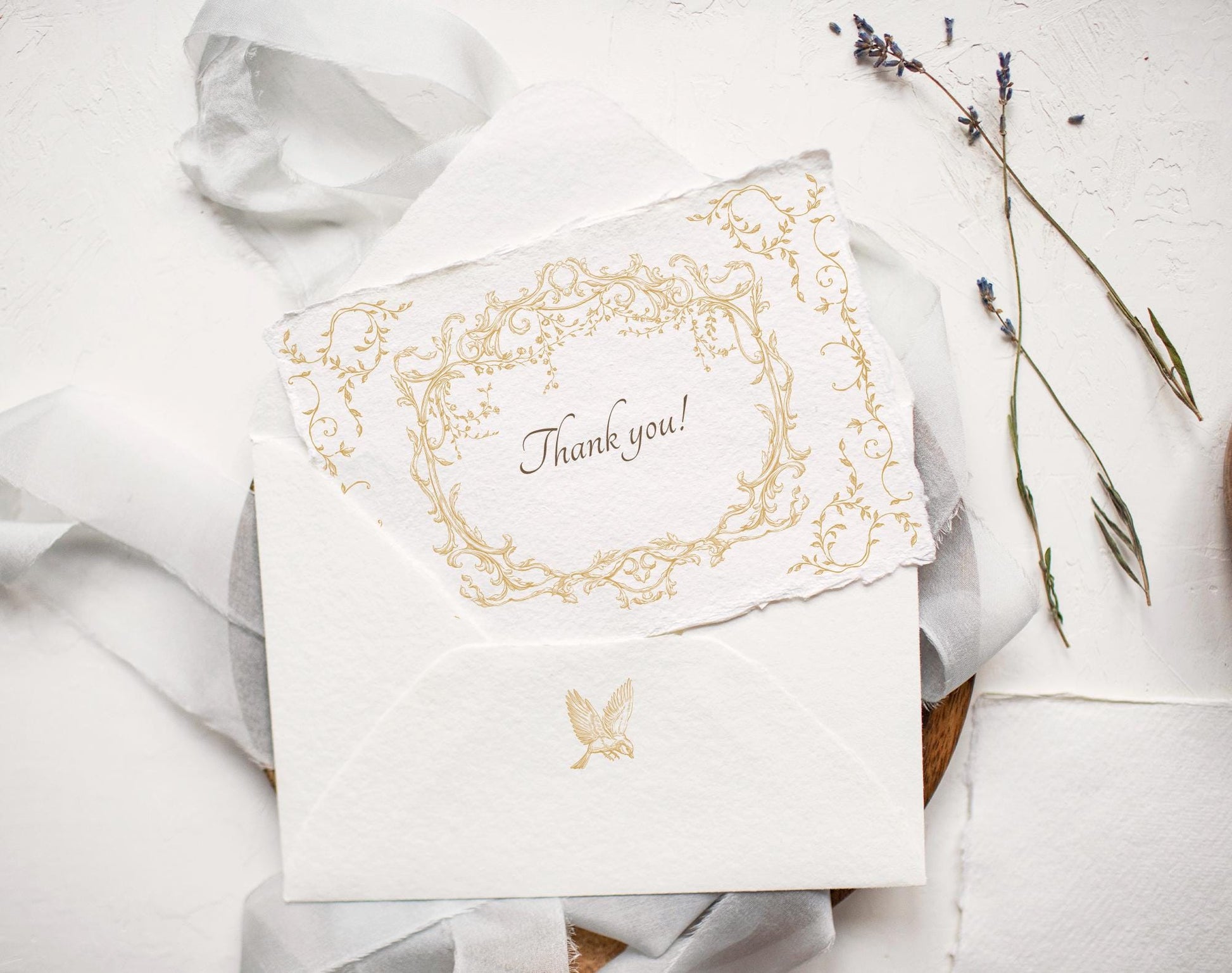 Envelope and thank-you card stamped with Ornella Gold floral frame