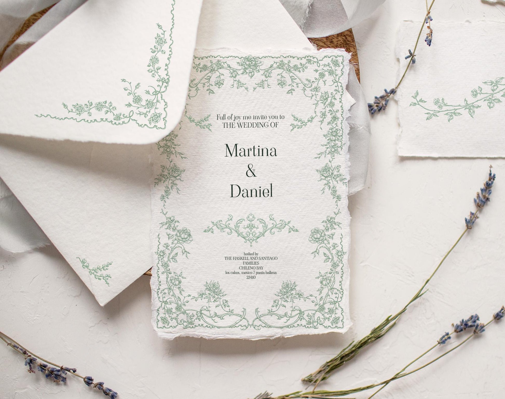 Wedding invitation mockup decorated with a delicate green Fleur D’Amour floral frame on textured paper.