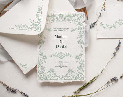 Wedding invitation mockup decorated with a delicate green Fleur D’Amour floral frame on textured paper.