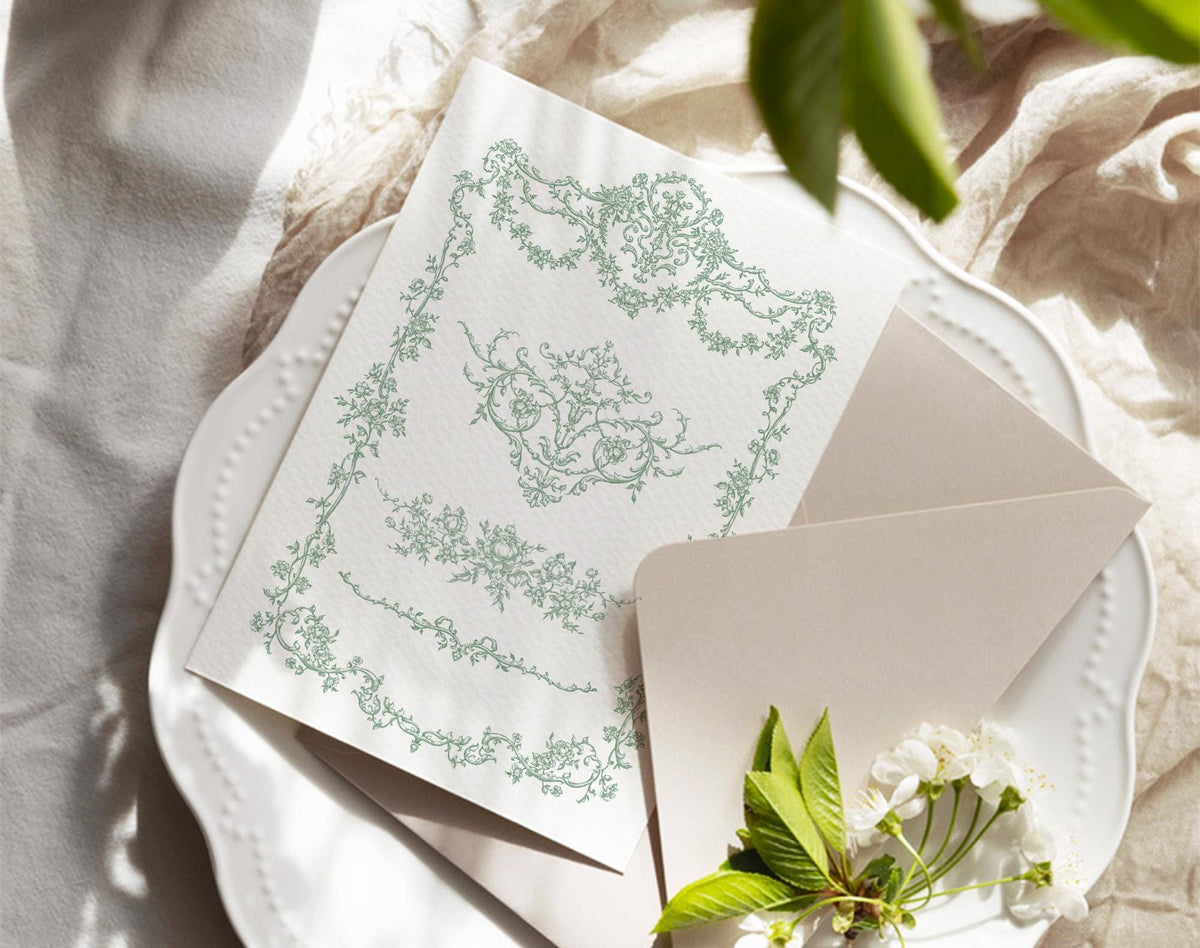 Floral Garden green floral frame shown on a printed card beside an envelope and fresh greenery.