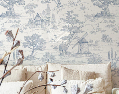 Wallpaper with a pastoral (Toile de Jouy) scene featuring trees and a windmill in a room with beige furniture.