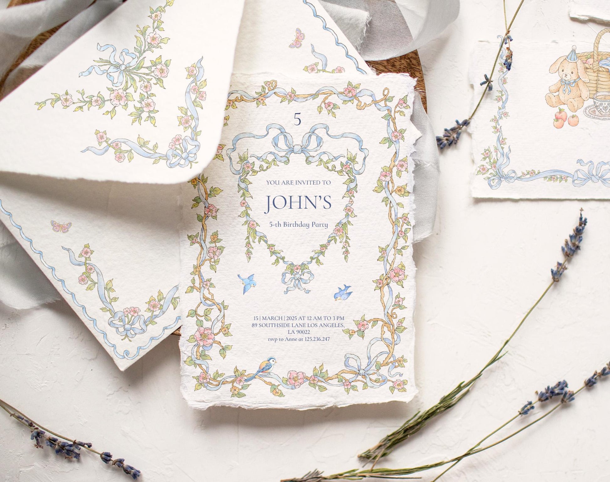 Styled stationery mockup featuring Little Bear floral border artwork, blue ribbons, and a teddy bear motif.