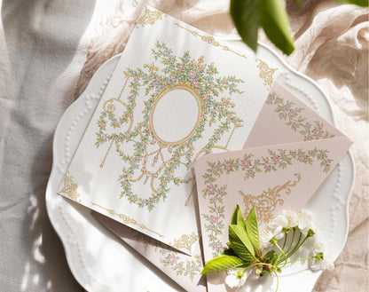 Vintage floral crest and rose border artwork displayed on a printed invitation card and matching envelope.